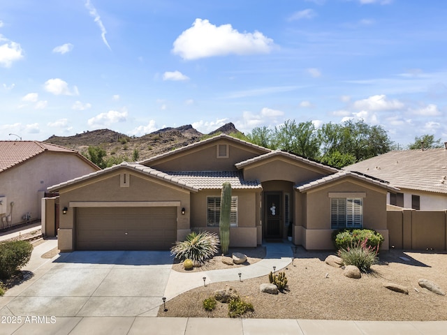 6213 W Gambit Trl, Phoenix, AZ 85083 - view of front of house with driveway, a tiled roof, an attached garage, and stucco siding
