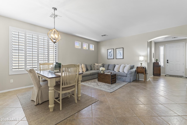 6213 W Gambit Trl, Phoenix, AZ 85083 - dining area featuring arched walkways, light tile patterned floors, a chandelier, and baseboards