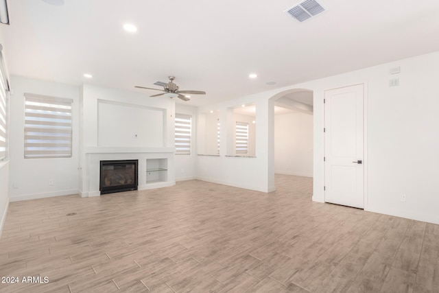 unfurnished living room with light hardwood / wood-style floors and ceiling fan