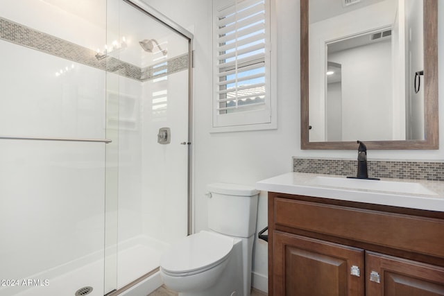 bathroom featuring walk in shower, decorative backsplash, vanity, and toilet