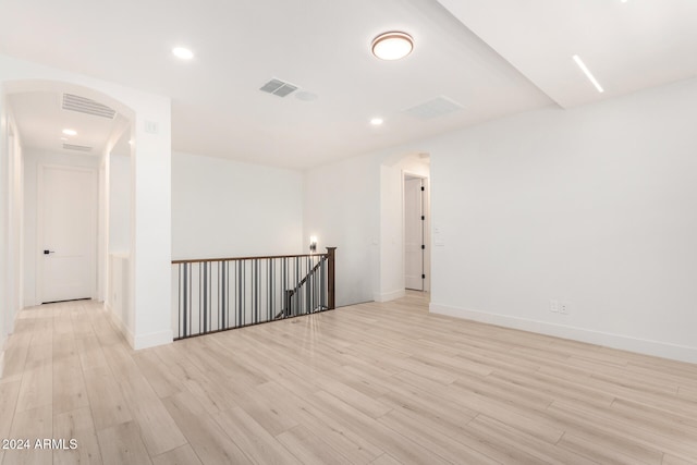 empty room with light hardwood / wood-style flooring