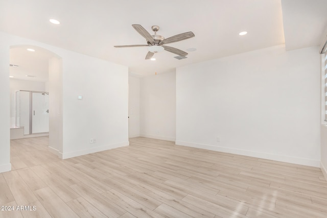 spare room featuring ceiling fan and light hardwood / wood-style floors