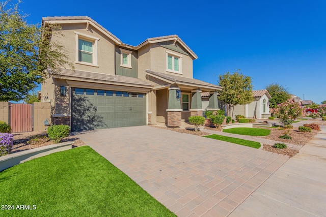 view of front of home featuring a garage and a front yard