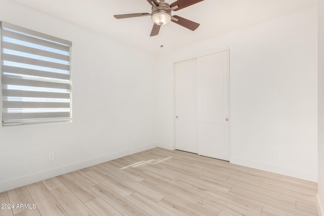 spare room with light hardwood / wood-style floors and ceiling fan