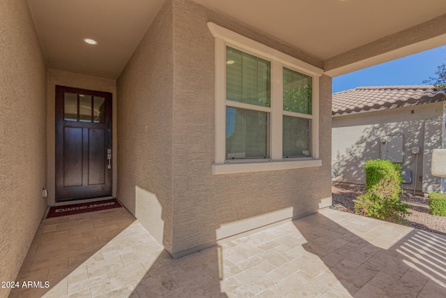 view of exterior entry featuring a patio