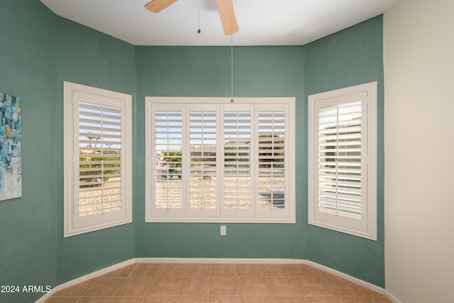 tiled empty room with ceiling fan