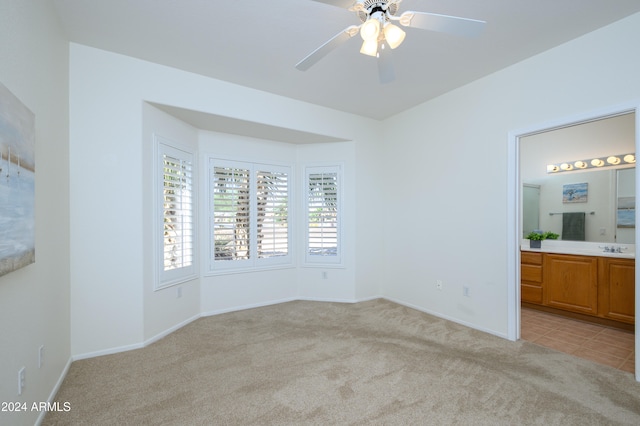 interior space with light carpet and ceiling fan