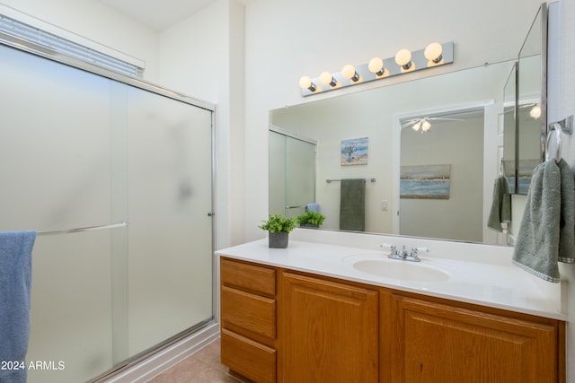 bathroom featuring vanity, ceiling fan, tile patterned flooring, and an enclosed shower