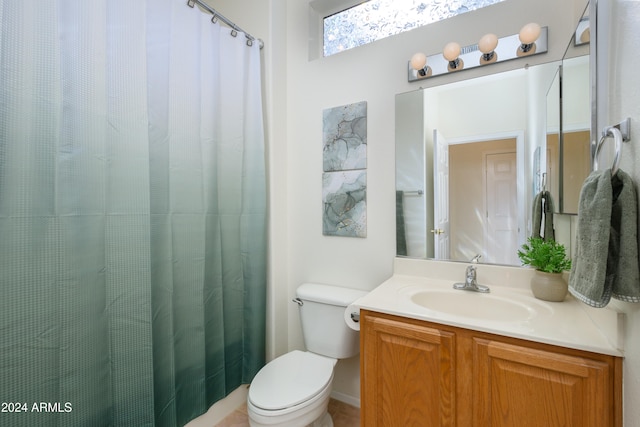 bathroom with vanity, toilet, and walk in shower