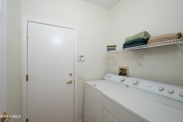 clothes washing area with washing machine and clothes dryer