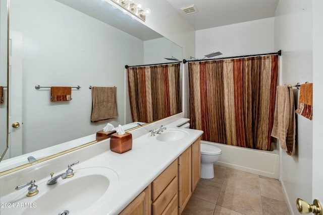 full bathroom featuring tile patterned flooring, vanity, shower / tub combo with curtain, and toilet