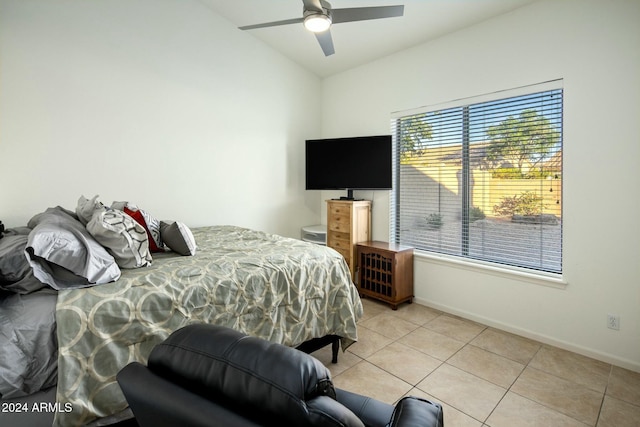 tiled bedroom featuring ceiling fan and lofted ceiling