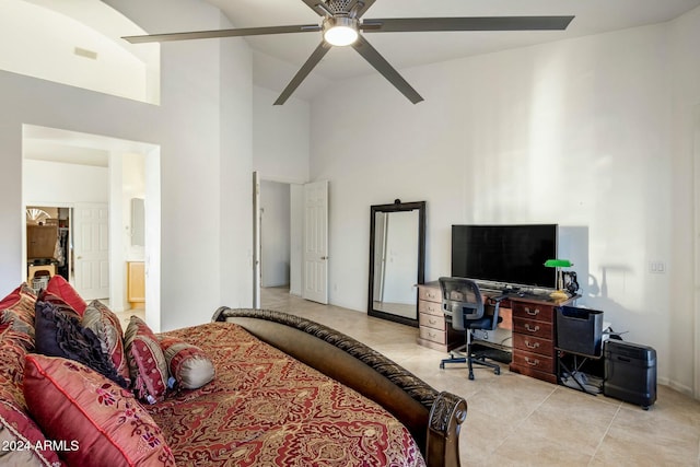 tiled bedroom with ensuite bathroom, high vaulted ceiling, and ceiling fan