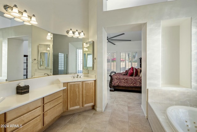 bathroom featuring tile patterned floors, vanity, ceiling fan, and a relaxing tiled tub