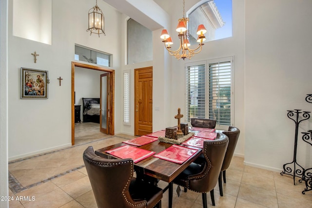 tiled dining area with a notable chandelier and a high ceiling