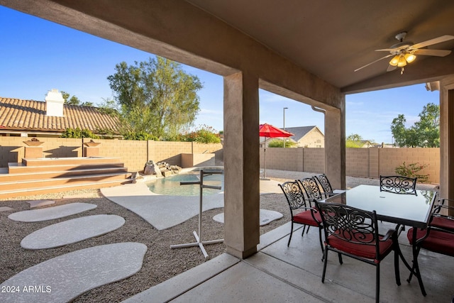 view of patio with a fenced in pool and ceiling fan