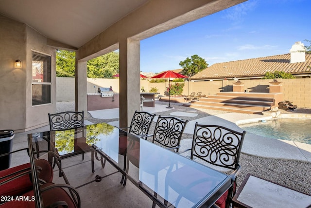 view of patio / terrace featuring an outdoor kitchen and a fenced in pool