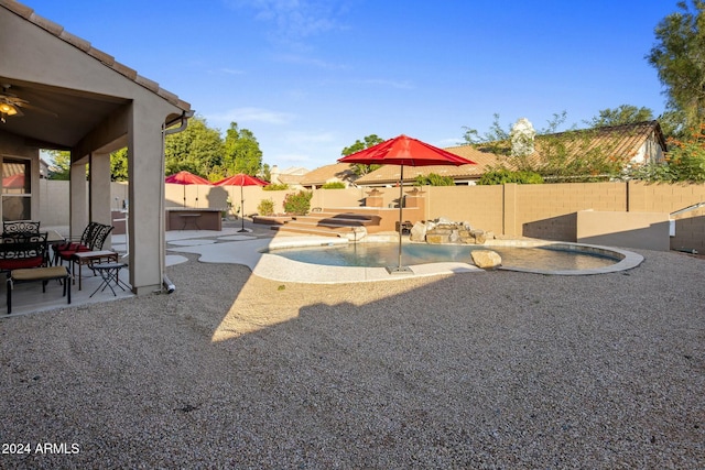 view of yard with a patio and a pool with hot tub