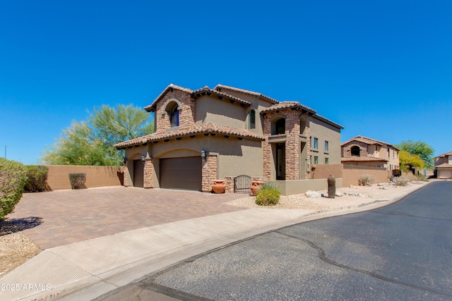 3030 N Saranac, Mesa, AZ 85207 - mediterranean / spanish-style house with stucco siding, stone siding, decorative driveway, an attached garage, and a tiled roof