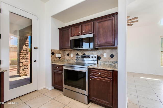 3030 N Saranac, Mesa, AZ 85207 - kitchen featuring appliances with stainless steel finishes, light tile patterned floors, tasteful backsplash, and light stone countertops