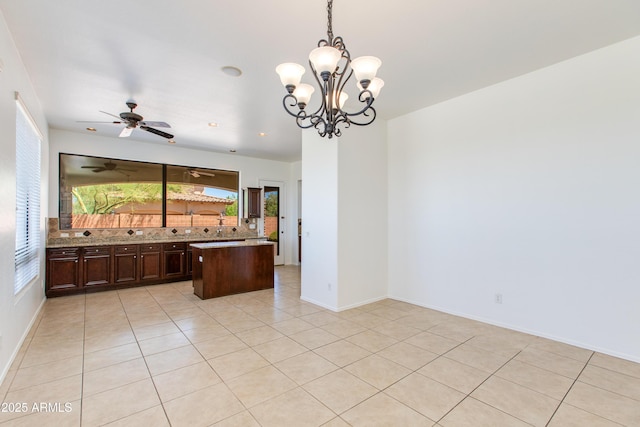 3030 N Saranac, Mesa, AZ 85207 - kitchen with tasteful backsplash, light tile patterned flooring, dark brown cabinets, hanging light fixtures, and a chandelier