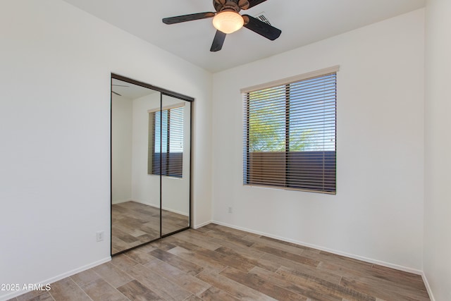 3030 N Saranac, Mesa, AZ 85207 - unfurnished bedroom with wood finished floors, a closet, and ceiling fan