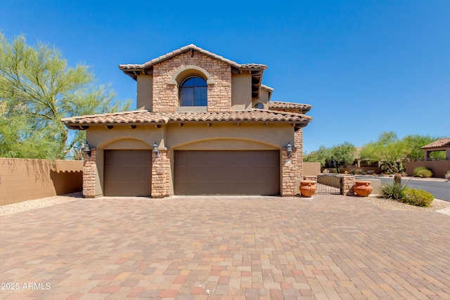 3030 N Saranac, Mesa, AZ 85207 - mediterranean / spanish home with stucco siding, a garage, a tiled roof, decorative driveway, and stone siding