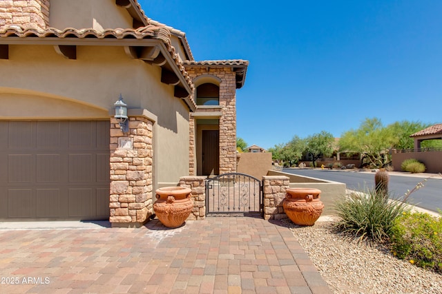 3030 N Saranac, Mesa, AZ 85207 - view of front of home featuring stucco siding, a gate, stone siding, and a tiled roof