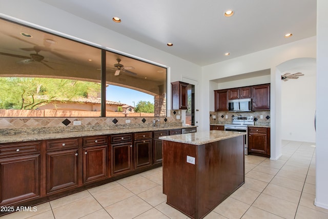 3030 N Saranac, Mesa, AZ 85207 - kitchen with appliances with stainless steel finishes, a ceiling fan, light tile patterned flooring, decorative backsplash, and recessed lighting
