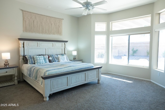 bedroom featuring ceiling fan and dark carpet