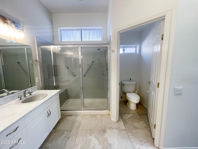 bathroom featuring vanity, toilet, and a shower with door