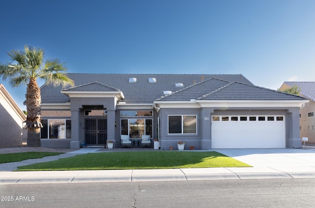 view of front of property with a garage and a front lawn