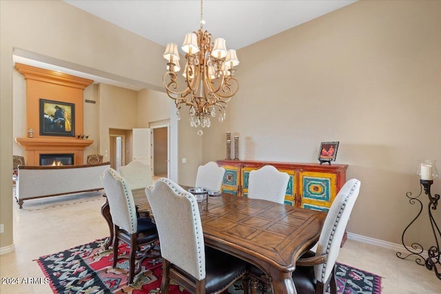 dining space with light tile patterned floors and an inviting chandelier