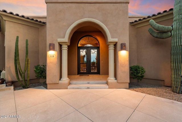 exterior entry at dusk with french doors