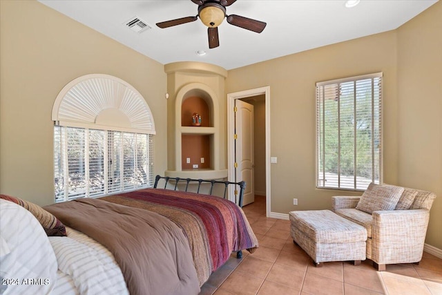 tiled bedroom featuring ceiling fan