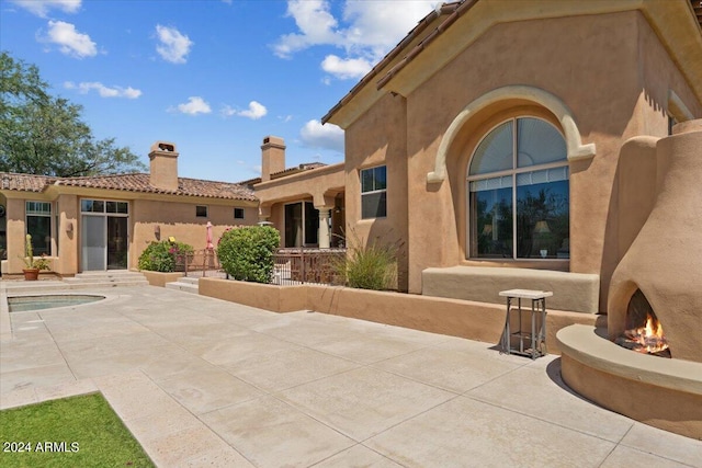 back of house with a patio and a pool