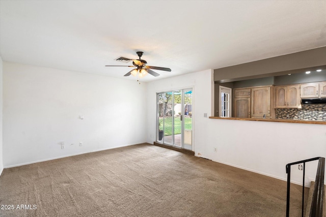 unfurnished living room featuring visible vents, baseboards, a ceiling fan, and carpet flooring