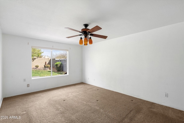 unfurnished room featuring a ceiling fan and carpet flooring