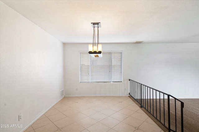 empty room featuring visible vents and baseboards