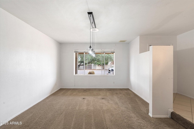 carpeted empty room featuring baseboards