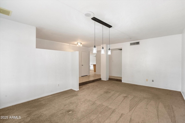 spare room featuring visible vents and carpet