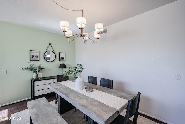 dining room featuring an inviting chandelier and dark hardwood / wood-style flooring