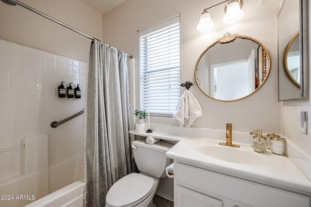 full bathroom with shower / bath combination with curtain, toilet, and vanity