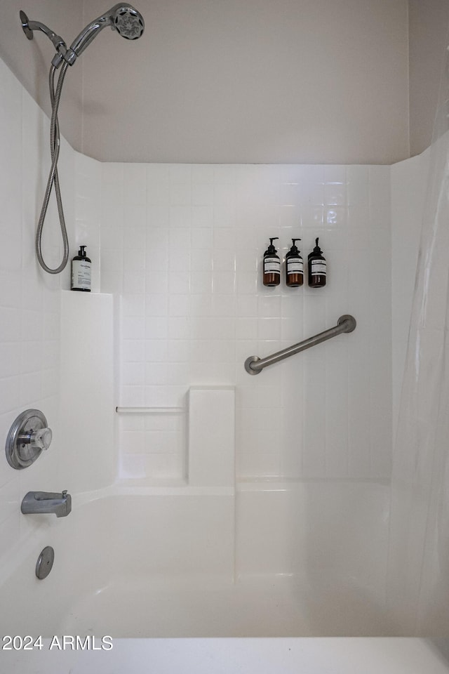 bathroom with shower / bath combination with curtain