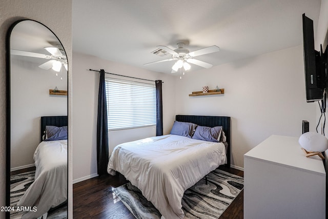 bedroom with dark hardwood / wood-style floors and ceiling fan