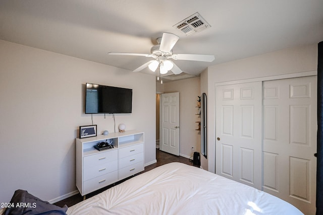 bedroom featuring a closet, ceiling fan, and dark hardwood / wood-style flooring