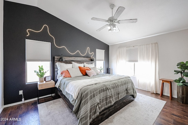 bedroom with dark wood-type flooring, ceiling fan, and lofted ceiling