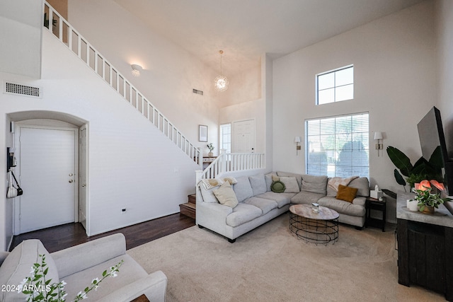 living room with a high ceiling and hardwood / wood-style flooring