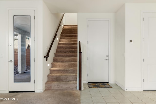 stairway featuring tile patterned floors and baseboards