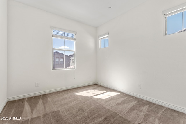 carpeted spare room with baseboards